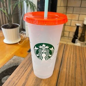 Starbucks refillable cup. Tie dye colored cup with a redish-orange lid.